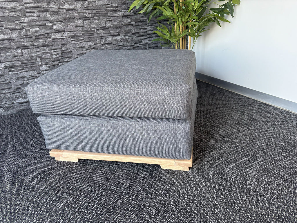 Velorra Glaciella Ottoman in Glaciella ribbed fabric on a solid Red Oak base