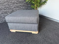 Velorra Glaciella Ottoman in Glaciella ribbed fabric on a solid Red Oak base