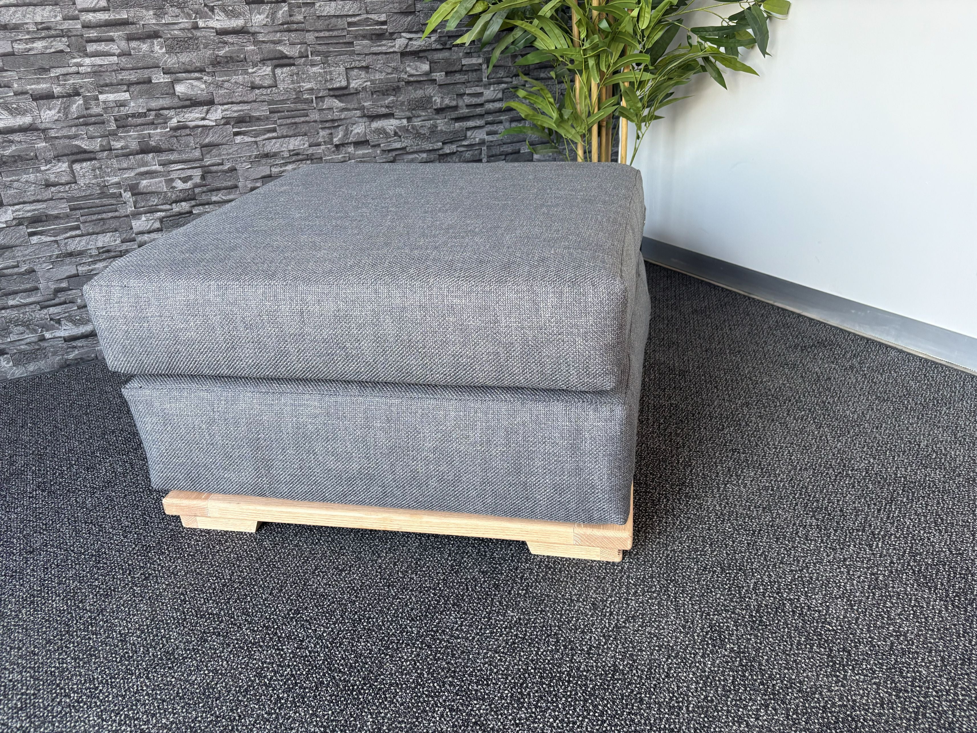 Velorra Glaciella Ottoman in Glaciella ribbed fabric on a solid Red Oak base